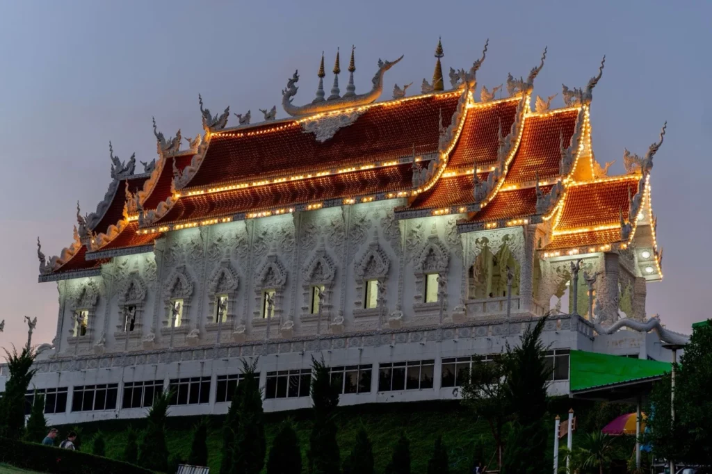 Wat Huay Pla Kang Tempel in Chiang Rai, erstrahlt abends in voller Pracht, ein kulturelles Highlight in Nordthailand.