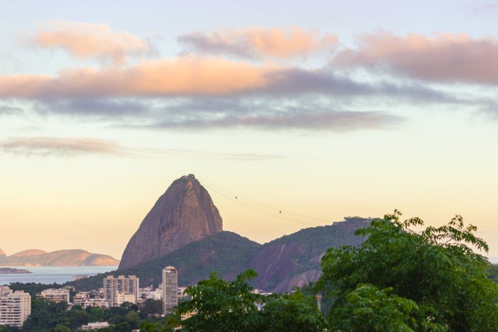 A breathtaking view of Sugarloaf Mountain with cityscape at sunset.