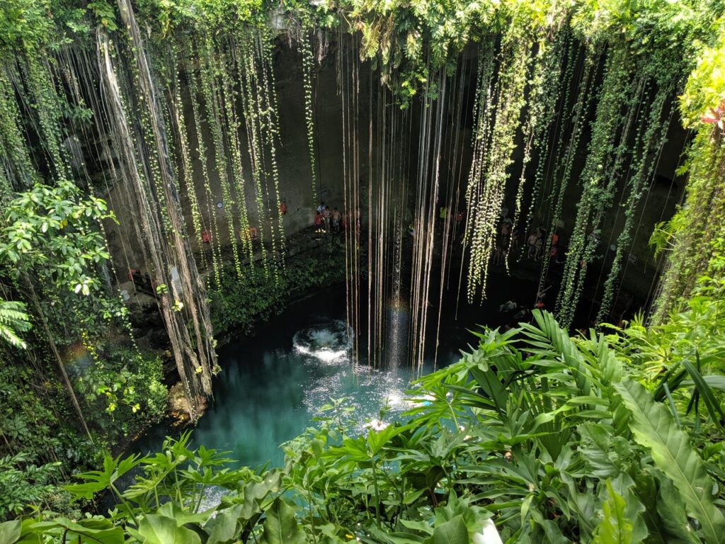 Beautiful view of Cenote Ik Kil surrounded by lush greenery in Yucatan, Mexico.